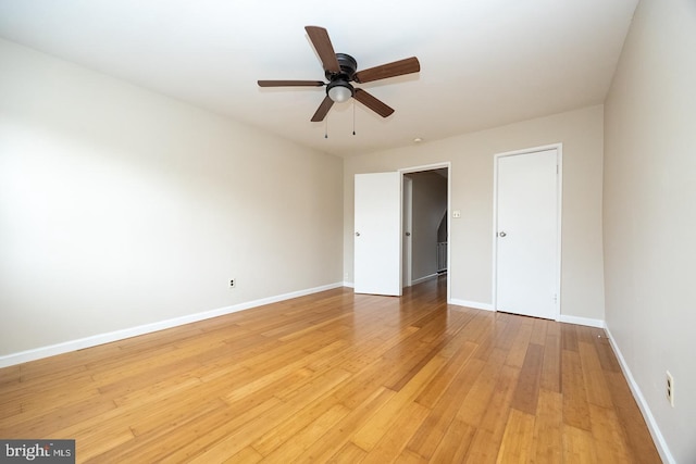 unfurnished bedroom with light wood-style flooring, baseboards, and ceiling fan