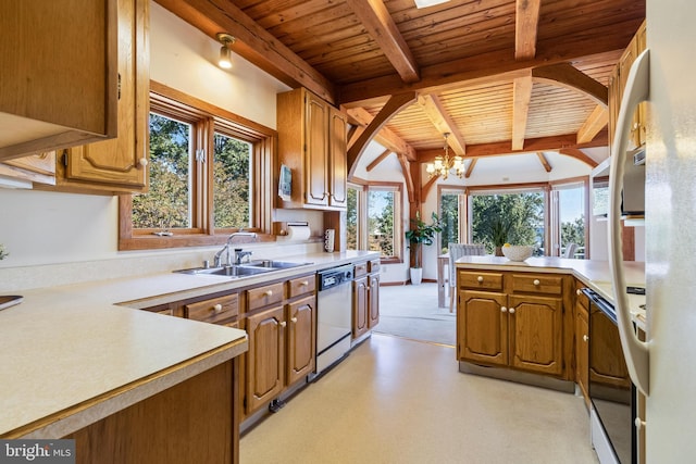5112 Shore Dr, Huntingtown, MD 20639 - kitchen featuring dishwashing machine, light countertops, a chandelier, and a sink