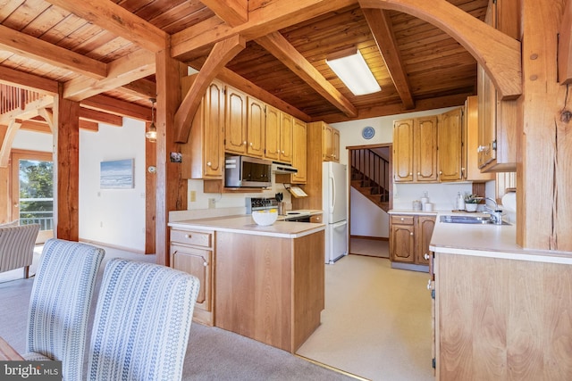 5112 Shore Dr, Huntingtown, MD 20639 - kitchen featuring beamed ceiling, a sink, stainless steel microwave, freestanding refrigerator, and light countertops