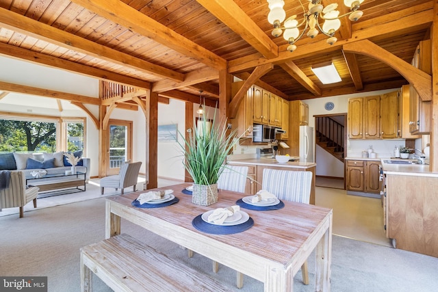 5112 Shore Dr, Huntingtown, MD 20639 - dining room featuring an inviting chandelier, wood ceiling, light colored carpet, and beam ceiling