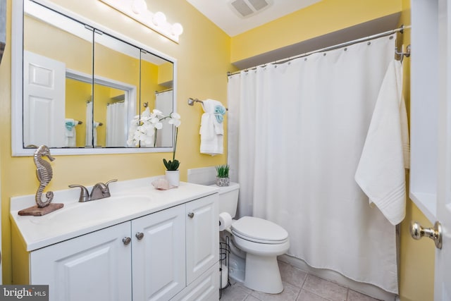 full bath featuring toilet, vanity, visible vents, and tile patterned floors