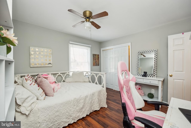 bedroom featuring a ceiling fan, a closet, and wood finished floors