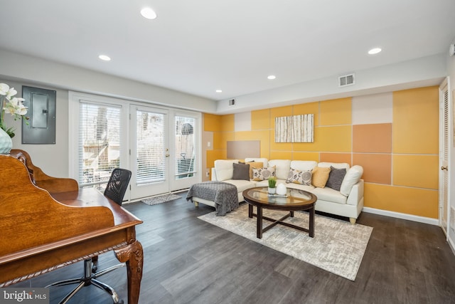 living room with wood finished floors, visible vents, and recessed lighting