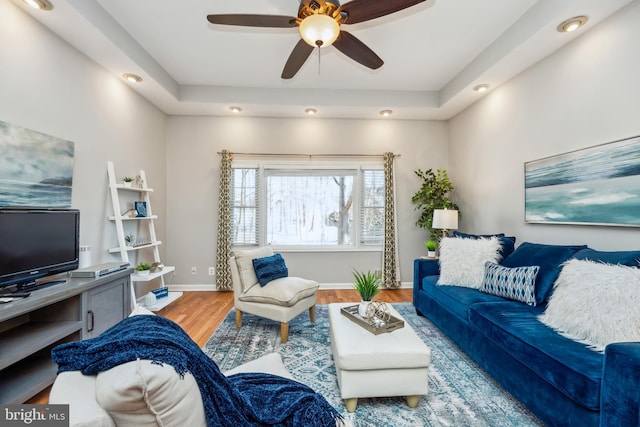 living room featuring a ceiling fan, baseboards, wood finished floors, and recessed lighting