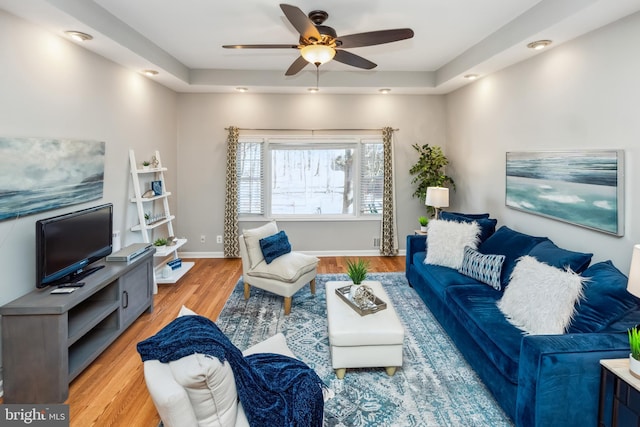 living room with ceiling fan, recessed lighting, light wood-type flooring, and baseboards