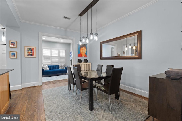 2652 Woodley Pl NW, Washington, DC 20008 - dining room featuring wood finished floors, baseboards, and ornamental molding