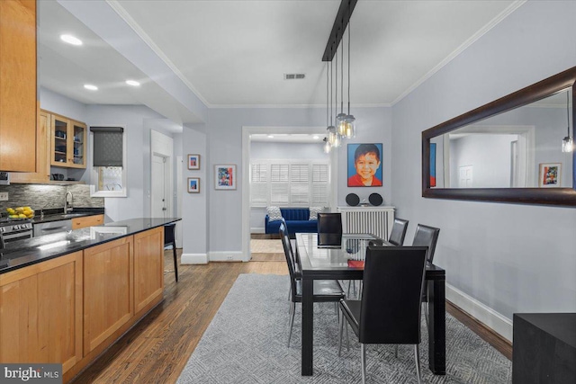 2652 Woodley Pl NW, Washington, DC 20008 - dining space with baseboards, dark wood-style floors, and ornamental molding