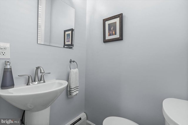 2652 Woodley Pl NW, Washington, DC 20008 - half bathroom featuring toilet, baseboards, and a sink