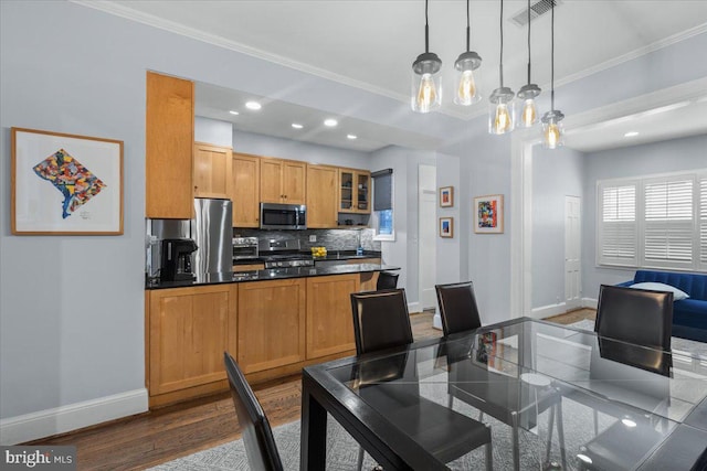 2652 Woodley Pl NW, Washington, DC 20008 - dining area featuring baseboards, ornamental molding, dark wood finished floors, recessed lighting, and a chandelier