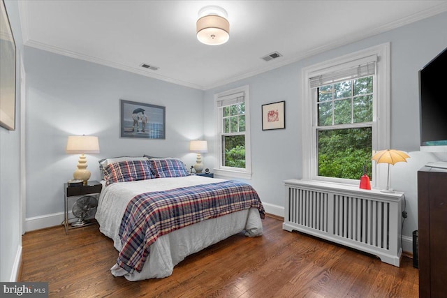2652 Woodley Pl NW, Washington, DC 20008 - bedroom featuring radiator heating unit, ornamental molding, wood finished floors, and baseboards