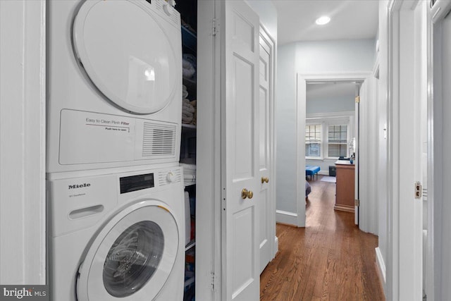 2652 Woodley Pl NW, Washington, DC 20008 - laundry room featuring stacked washer / dryer, dark wood-style floors, recessed lighting, and baseboards