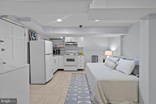 2652 Woodley Pl NW, Washington, DC 20008 - bedroom featuring freestanding refrigerator, light tile patterned floors, washer / clothes dryer, and recessed lighting