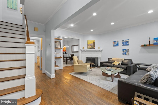 2652 Woodley Pl NW, Washington, DC 20008 - living room featuring ornamental molding, stairway, wood finished floors, recessed lighting, and a fireplace
