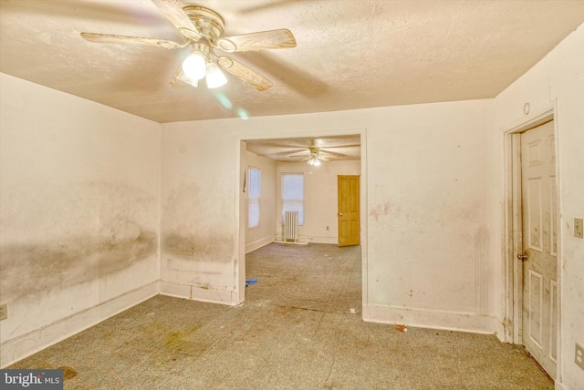 unfurnished room featuring a textured ceiling and a ceiling fan