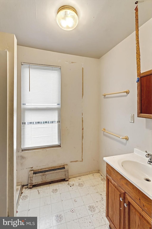 bathroom featuring a baseboard heating unit, vanity, and tile patterned floors