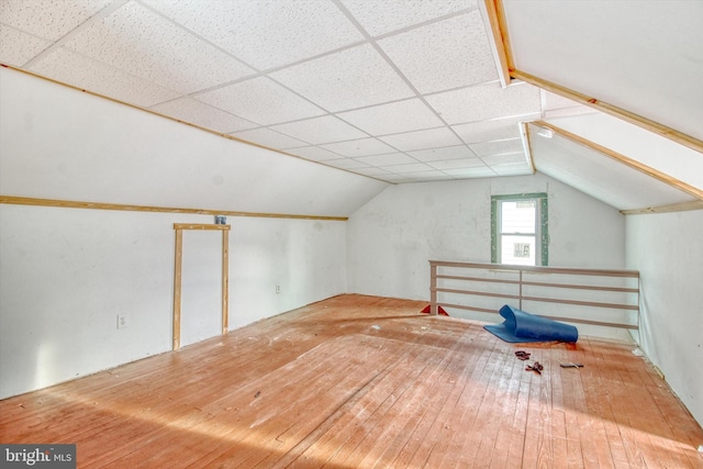 bonus room with lofted ceiling and wood-type flooring