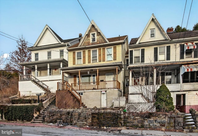 multi unit property featuring covered porch and stairway