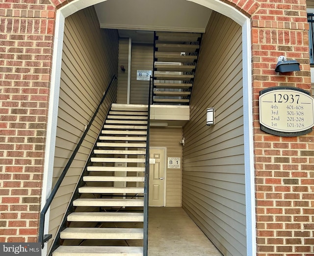 property entrance featuring brick siding