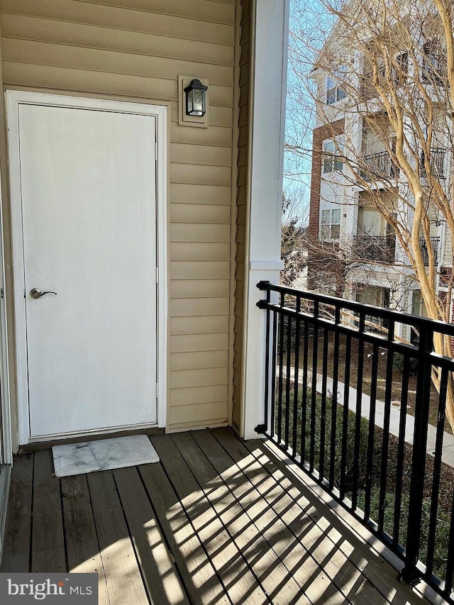 view of exterior entry with a balcony