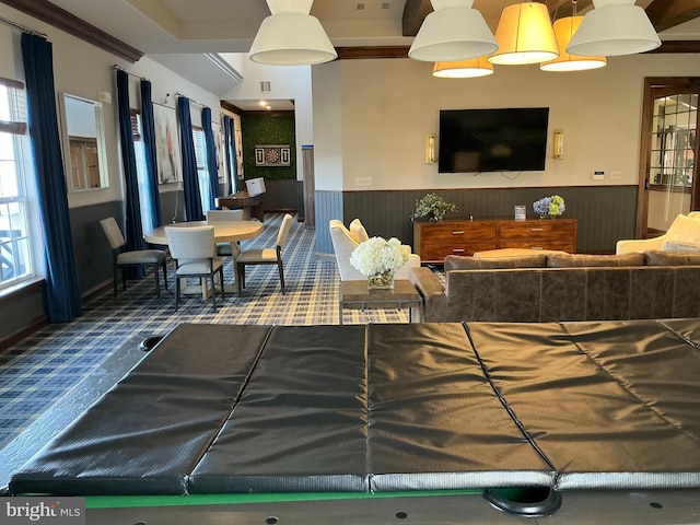 living area with visible vents and wainscoting