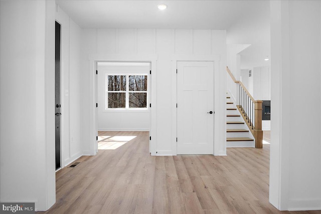 interior space featuring stairs, baseboards, and wood finished floors