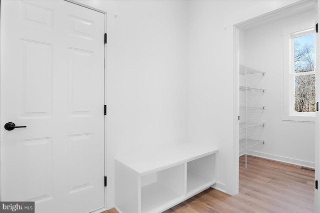 mudroom with light wood-style floors and baseboards