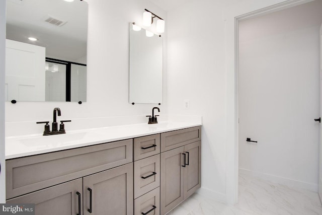 full bath with marble finish floor, baseboards, visible vents, and a sink