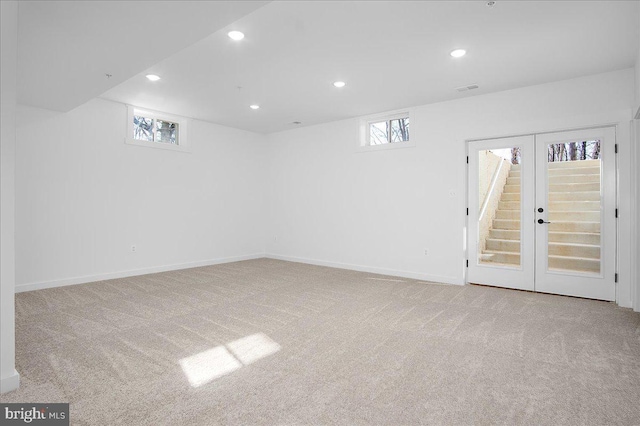 below grade area featuring plenty of natural light, baseboards, carpet flooring, and recessed lighting