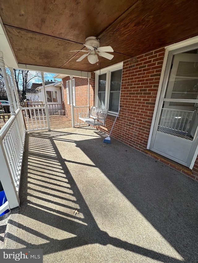 view of patio featuring ceiling fan and a porch