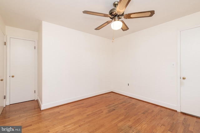 unfurnished room featuring a ceiling fan, light wood-type flooring, and baseboards