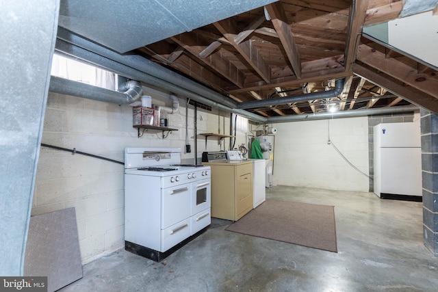 below grade area featuring freestanding refrigerator and washing machine and clothes dryer