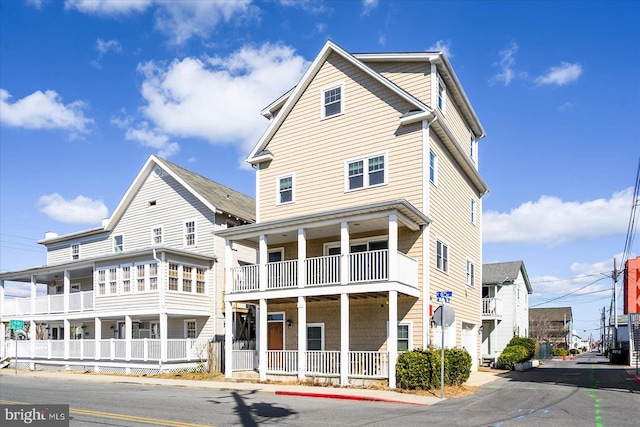 exterior space featuring covered porch and a balcony