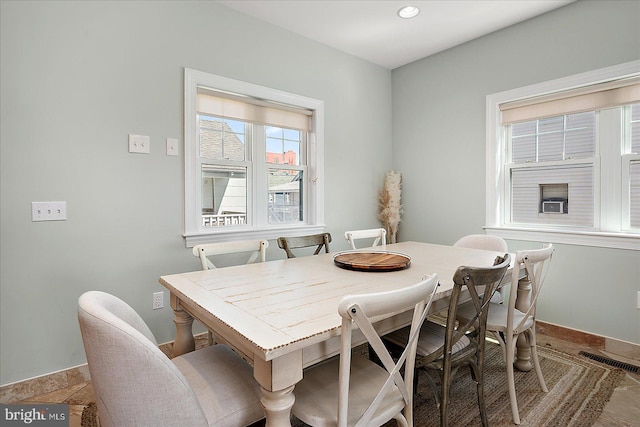 dining space featuring visible vents and baseboards