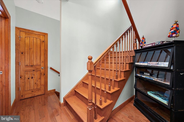 stairs featuring baseboards and wood finished floors