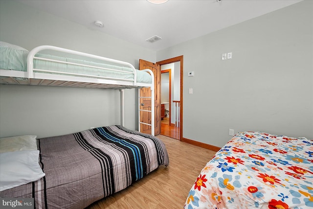 bedroom featuring light wood-style floors, baseboards, and visible vents