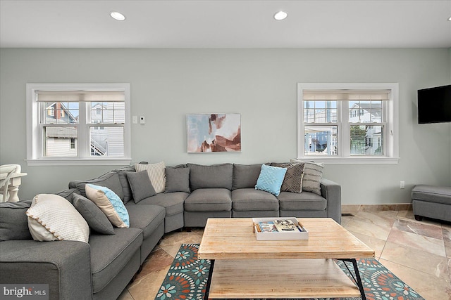 living area with baseboards and recessed lighting