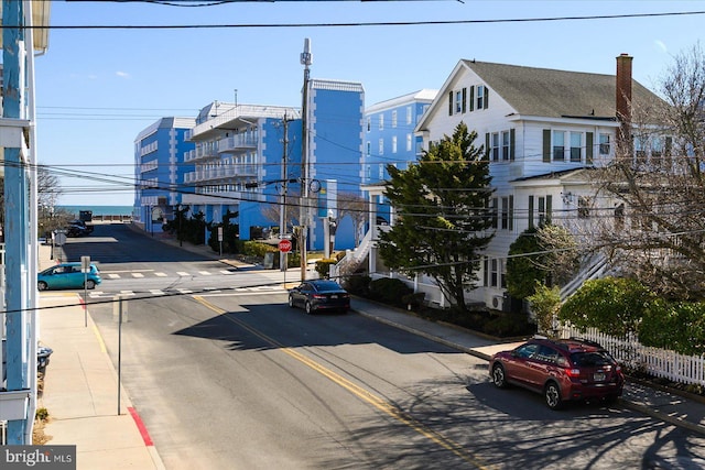 view of road with curbs, traffic signs, and sidewalks