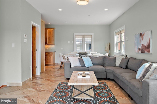 living area with recessed lighting and baseboards