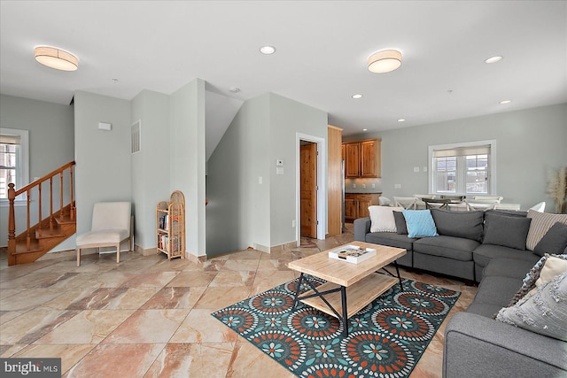 living area with visible vents, stairway, baseboards, and recessed lighting