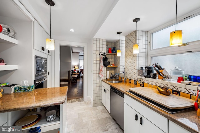 kitchen featuring white cabinets, appliances with stainless steel finishes, open shelves, and decorative backsplash