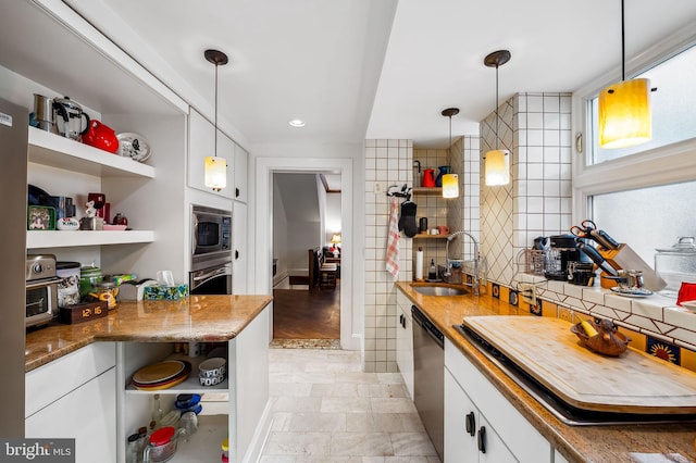 kitchen with white cabinets, appliances with stainless steel finishes, open shelves, and a sink