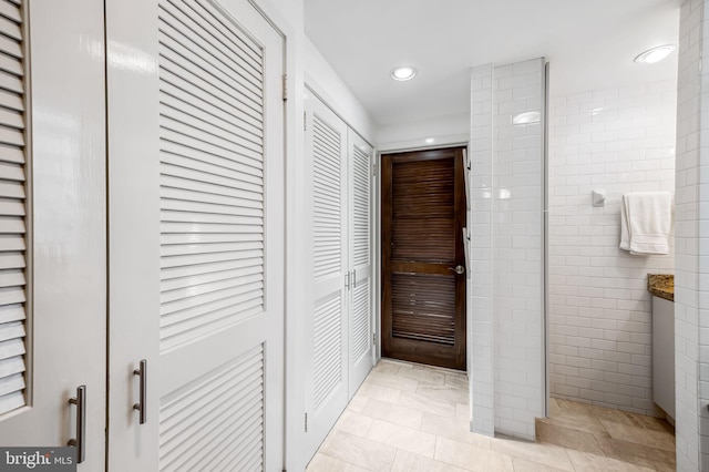 bathroom featuring recessed lighting, a closet, and tiled shower