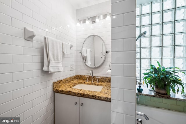 bathroom with tile walls and vanity