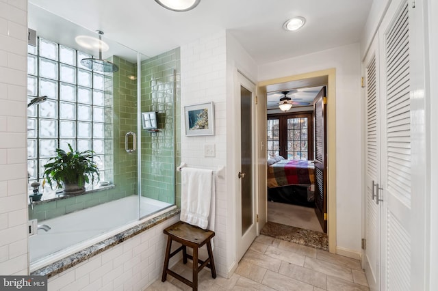 full bathroom with baseboards, a ceiling fan, tiled shower / bath combo, french doors, and a closet