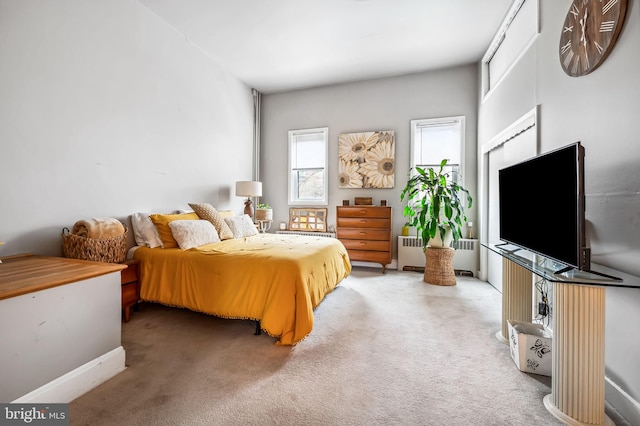 carpeted bedroom featuring radiator