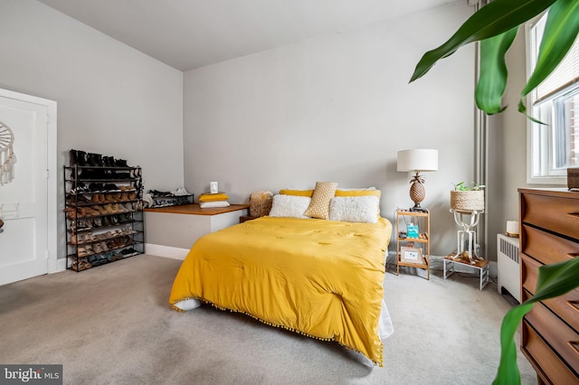 carpeted bedroom with radiator heating unit