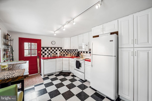 kitchen with dark floors, backsplash, white cabinetry, track lighting, and white appliances