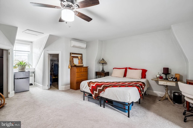 bedroom with an AC wall unit, radiator, carpet, a walk in closet, and attic access