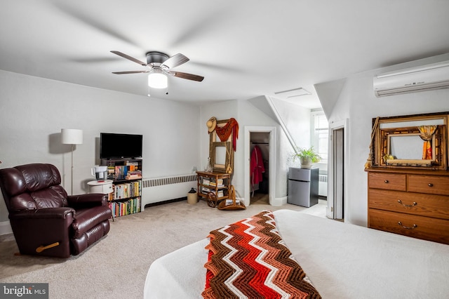 interior space featuring a ceiling fan, radiator, freestanding refrigerator, carpet flooring, and a wall mounted AC