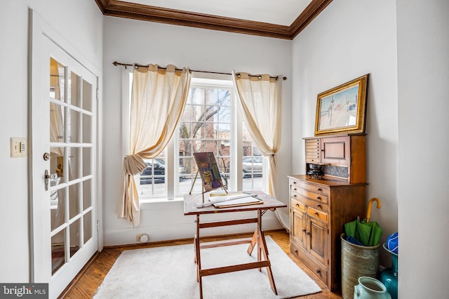 office space with baseboards, ornamental molding, and wood finished floors